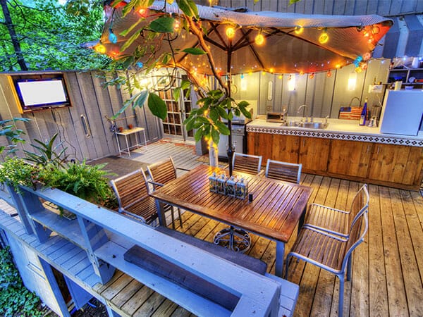 outdoor patio with table and chairs to show custom speaker set up